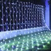 A net of white lights draped over a fence and onto the grass. Produktbild-Vorschau