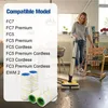 A woman is using a floor cleaner in a living room, with replacement rollers shown in the foreground. Produktbild-Vorschau