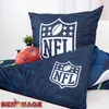 A close-up view of NFL-themed bedding and a football. Náhled obrázku produktu