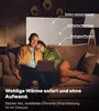 A couple relaxing on a couch, looking at a laptop, with an infrared heater implied to be in use. Voir les images du produit