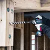 A person is using a cordless drill to drill a large hole in a wooden beam. The drill has a large auger bit attached. The background shows the interior of a building under construction. Anteprima dell’immagine prodotto
