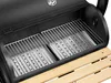 Close-up view inside a black charcoal smoker grill with stainless steel grates and perforated metal inserts. Produktbild-Vorschau