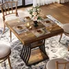 A dining table set for four, with a floral arrangement in the center, set in a dining room. Podgląd zdjęcia produktu