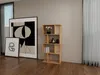 A wooden bookshelf with books, vases, and flowers is placed next to two framed pictures in a room with a window and curtains. Produktbild-Vorschau