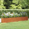 A wooden planter box filled with purple flowers in a garden setting. Podgląd zdjęcia produktu