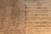 Close-up view of a wooden surface, likely a tabletop or flooring, showing wood grain and texture. Produktbild-Vorschau