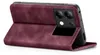 A burgundy flip case for a smartphone is shown open, propped up to reveal the phone's camera module. Produktbild-Vorschau