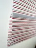 A close-up view of a striped roller blind, partially rolled up. Produktbild-Vorschau