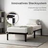 A bed frame with a mattress and bedding in a room setting. Voir les images du produit