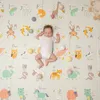 A baby sleeping on a colorful alphabet play mat with various animal illustrations and toys scattered around. Náhľad obrázku produktu
