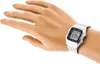 A person's wrist wearing a silver digital watch. Produktbild-Vorschau