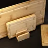 Several bamboo cutting boards are displayed on a black surface, with one smaller board propped up by a wooden stand. Produktbild-Vorschau