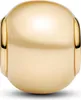 A close-up studio shot of a single gold charm. Podgląd zdjęcia produktu