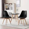 Two black chairs and a small round table are set up in a room with a white cabinet and a framed picture on the wall. Produktbild-Vorschau