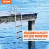 A dock ladder is partially submerged in blue water next to a wooden dock. Náhľad obrázku produktu