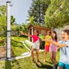 Children playing with water guns in a backyard with a shower stand. Náhľad obrázku produktu