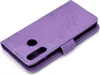 A purple flip case for a Huawei P30 Lite phone with a mandala pattern embossed on it. Produktbild-Vorschau