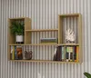 A wooden wall shelf with books, a plant, and a decorative item. Podgląd zdjęcia produktu