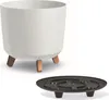 A white planter pot with wooden legs and a black saucer are displayed against a white background. Náhľad obrázku produktu