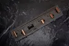 A set of bathroom hooks in a copper finish, laid out on a dark, textured surface. Produktbild-Vorschau