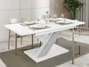 A dining table set up for a meal in a modern dining room. Anteprima dell’immagine prodotto