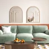 A living room scene with a green sofa, coffee table, and decorative mirrors on the wall. Náhľad obrázku produktu