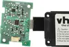 A circuit board connected to a black module with text. Produktbild-Vorschau