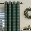 A close-up of plaid curtains with a Christmas wreath and tree decoration in the background. Podgląd zdjęcia produktu