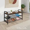 A shoe rack with shoes on it, placed in a room with a rug and a plant. Náhled obrázku produktu