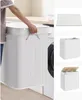A person is shown placing a lid on a white bamboo laundry basket next to a washing machine. The collage also shows close-ups of the laundry basket and a flat lay of a similar item. Produktbild-Vorschau