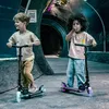 Two children riding scooters in a tunnel-like aquarium. Voir les images du produit