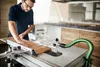 A man is using a table saw in a workshop or kitchen setting. Podgląd zdjęcia produktu