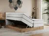 A bedroom scene featuring a king-size bed with its storage compartment open, showcasing the mattress and bed frame. Produktbild-Vorschau