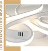 A close-up abstract view of a modern LED ceiling light with swirling white elements and integrated lighting. Podgląd zdjęcia produktu