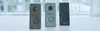Three smart doorbells in different colors are lined up on a white surface with a blurred background. Produktbild-Vorschau