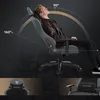 A man is reclining in a gaming chair, demonstrating its recline feature with angle indicators. Produktbild-Vorschau