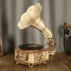 A wooden model of a vintage gramophone sits on a wooden surface. Náhľad obrázku produktu