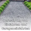 A gravel driveway with decorative bushes on the sides, overlaid with text. Produktbild-Vorschau