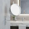 A close-up shot of a wall-mounted makeup mirror with LED lighting in a bathroom. Náhled obrázku produktu