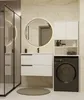 A modern bathroom with a vanity, mirror, and washing machine. Produktbild-Vorschau