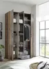 An open wardrobe with clothes and folded towels inside, placed in a room with a window. Produktbild-Vorschau