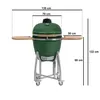 A green ceramic kamado grill with wooden side tables, shown with dimensions indicated by lines and text. Produktbild-Vorschau