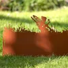 A rusted metal garden border with a fairy silhouette sitting amongst grass and reeds, placed on a lawn. Produktbild-Vorschau