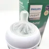 Close-up of a Philips Avent baby bottle nipple and neck, with the product packaging blurred in the background. Podgląd zdjęcia produktu