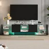 A modern TV stand with integrated LED lighting, displaying various decorative items and electronics. Produktbild-Vorschau