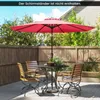 A patio set with a table, chairs, and umbrella on a wooden deck. Produktbild-Vorschau