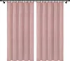 Two pink velvet curtains hanging on a black curtain rod against a white background. Podgląd zdjęcia produktu