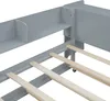 A close-up view of a grey wooden bed frame, showing the slatted base and built-in shelving. Podgląd zdjęcia produktu