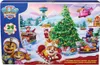 A festive holiday scene with Paw Patrol characters and a Christmas tree, depicted on the packaging of an advent calendar. Podgląd zdjęcia produktu