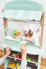 Children playing with a toy market stall. Produktbild-Vorschau
